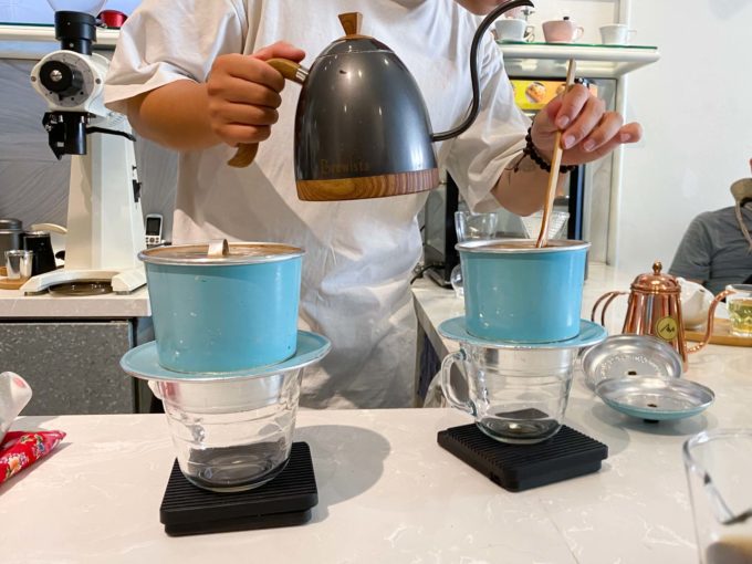 brewing coffee in large Vietnamese metal filters